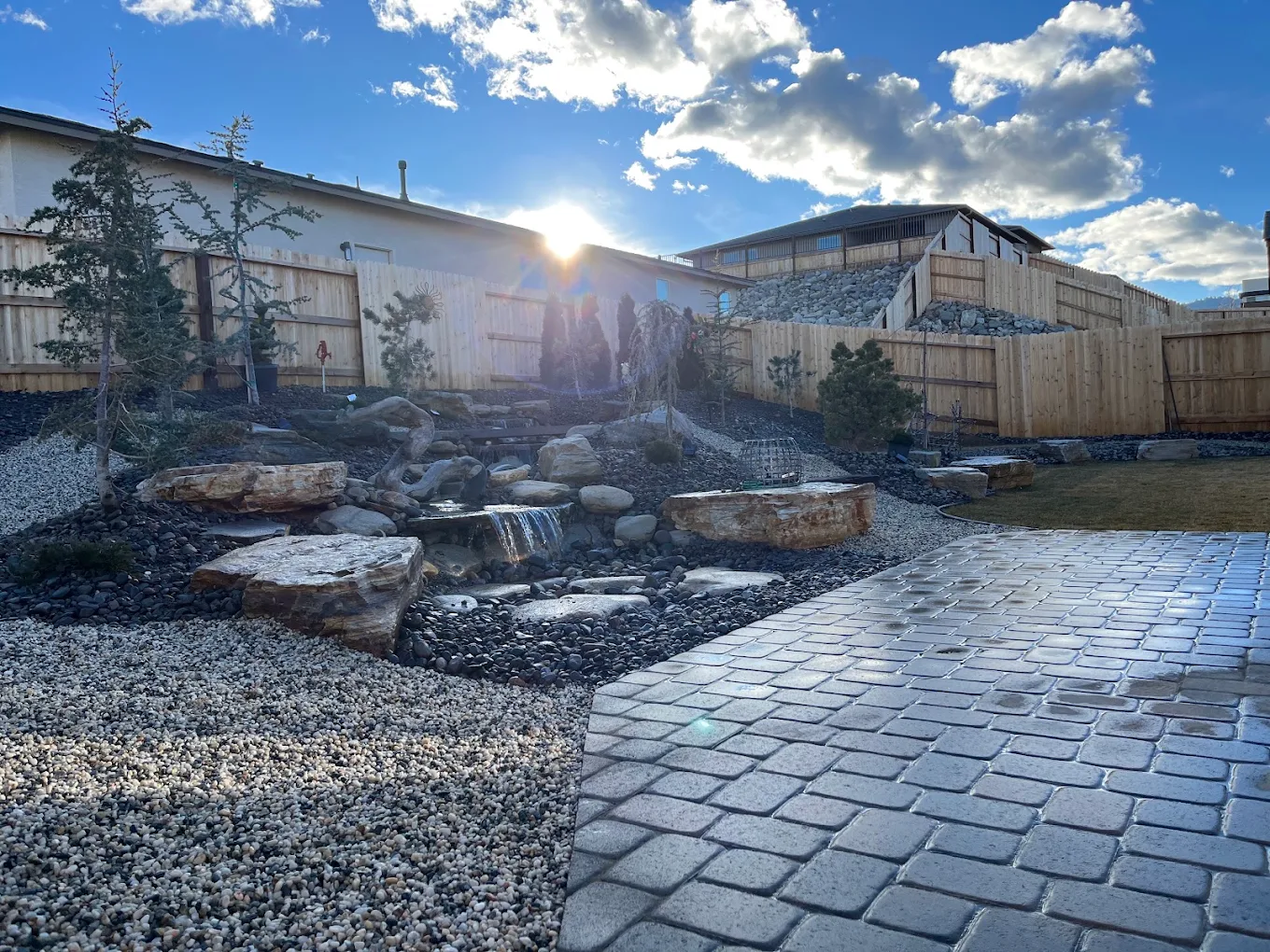Completed outdoor landscape with a water feature